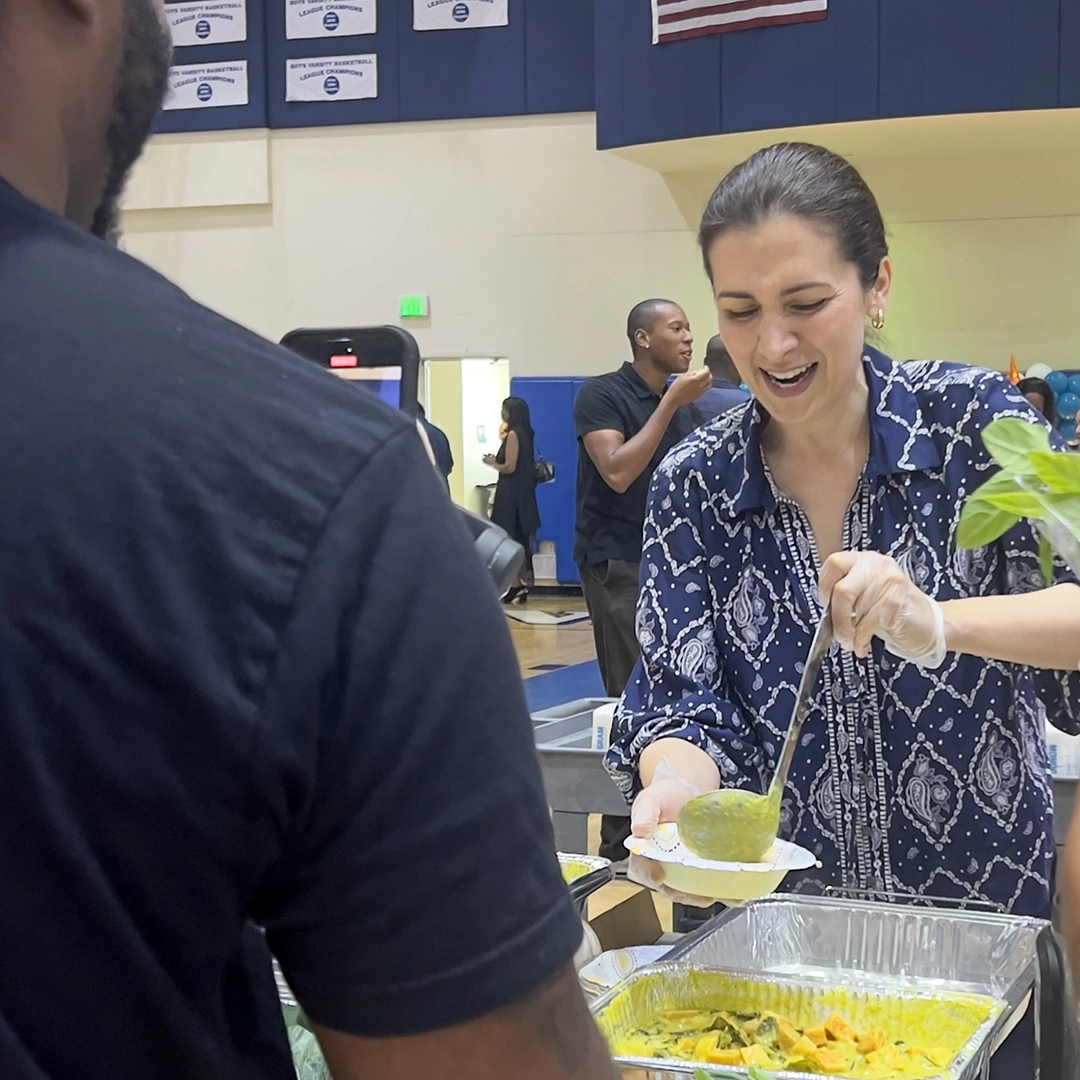 Community volunteer serving healthy food at INSPIRE event