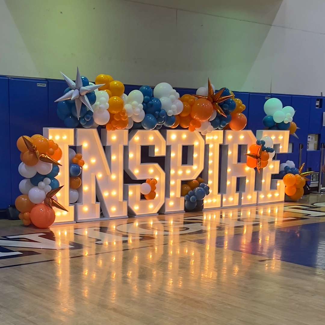 INSPIRE marquee sign with colorful balloon decorations