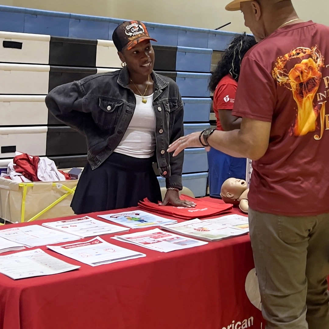 Health educator sharing information at community booth